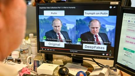 FILE PHOTO: A journalist views a deepfake video manipulated with AI, at an AFP newsdesk in Washington, DC.