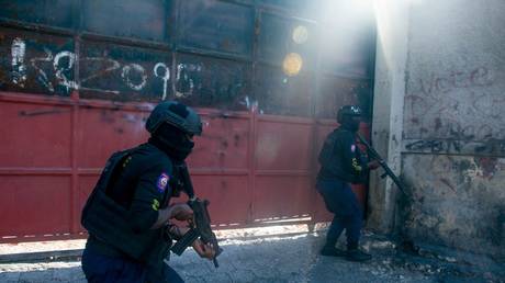 Police monitor a street after gang violence erupted in Port-au-Prince, Haiti, March 22, 2024.