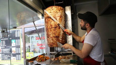 An employee prepares a customer's order at Mustafas Gemuse Kebap in Berlin, Germany, July 6, 2022