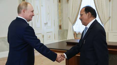 Russian President Vladimir Putin shakes hands with Indian National Security Advisor Ajit Doval before a meeting at the Constantine Palace in Strelna in the suburb of St. Petersburg, Russia.