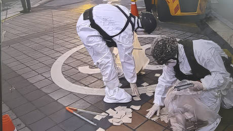 FILE PHOTO. Soldiers check a balloon carrying trash presumably sent by North Korea in a street in Seoul, South Korea.