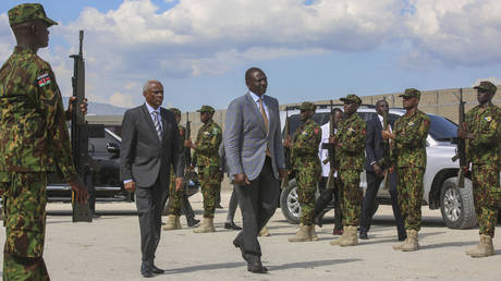 Kenya's President William Ruto, center right, walks with Transition Council President Edgard Leblanc, as they arrive to the Kenyan base in Port-au-Prince, Haiti, Saturday, Sept. 21, 2024.