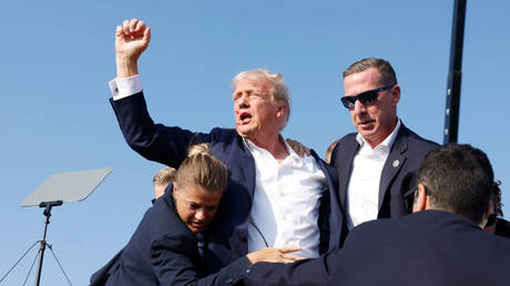 Former US President Donald Trump is rushed offstage after being shot during a rally on July 13, 2024 in Butler, Pennsylvania.  /Anna Moneymaker