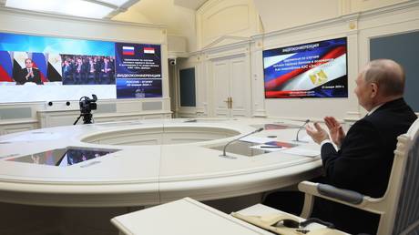 Russian President Vladimir Putin and Egyptian President Abdel Fattah el-Sisi take part, via videoconference, in the official ceremony for pouring the first concrete into the foundation of power unit 4 at Egypt's El-Dabaa Nuclear Power Plant, at Kremlin, in Moscow, Russia.