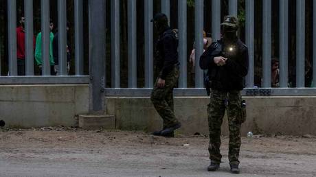 Polish border guards patrol along the border wall at Polish-Belarus border.