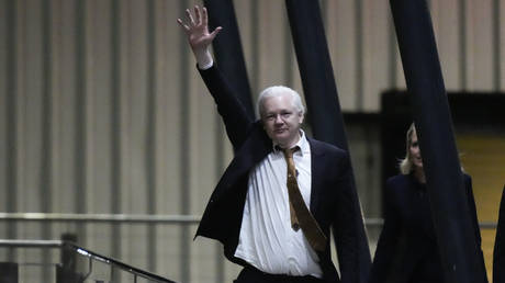 WikiLeaks founder Julian Assange waves after landing at RAAF air base Fairbairn in Canberra, Australia, Wednesday, June 26 2024.