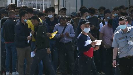 FILE PHOTO. A crowd of migrants pictured near the Joint Migration Center of Moscow Region, Russia.