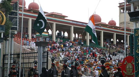 Indian Border Security Force (BSF) personnel and Pakistani Rangers (in black) perform the daily retreat ceremony at the India-Pakistan Wagah border post, about 35 km from Amritsa, on July 13, 2024, in Lahore, Pakistan.