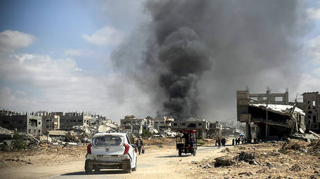 Smoke rises among the residential areas after Israeli attacks in Gaza.