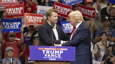 Republican Senate candidate Tim Sheehy shakes hands with Republican presidential nominee former President Donald Trump in Bozeman, Montana, Aug. 9, 2024