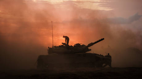 An Israeli Merkava battle tank halts near the border of Gaza in southern Israel, October 14, 2023