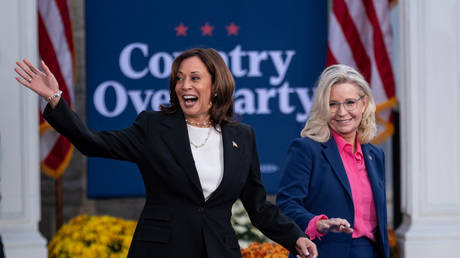 Kamala Harris (L) and Liz Cheney greet supporters during a campaign rally in Ripon, Wisconsin, October 3, 2024