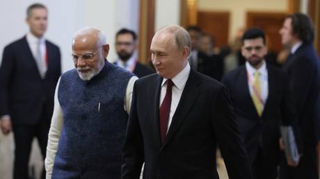 Russian President Vladimir Putin and Indian Prime Minister Narendra Modi arrive for a meeting on the sidelines of the the 16th BRICS summit in Kazan, Republic of Tatarstan, Russia.