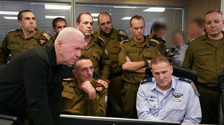 Israeli Defense Minister Yoav Gallant (1st L, front) at the Israeli Air Force’s underground command room September 27, 2024.