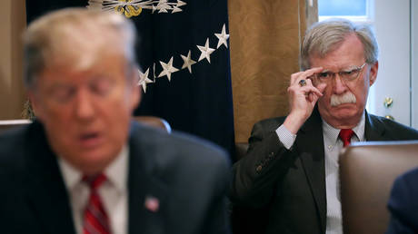 FILE PHOTO: National Security Advisor John Bolton listens to US President Donald Trump talking to reporters in February 12, 2019.