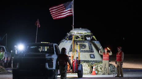 Boeing and NASA teams work around NASA's Boeing Crew Flight Test Starliner spacecraft.