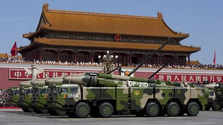 Chinese military vehicles drive past the Tiananmen Gate during a military parade to mark the 70th anniversary of the end of World War Two on September 3, 2015 in Beijing, China