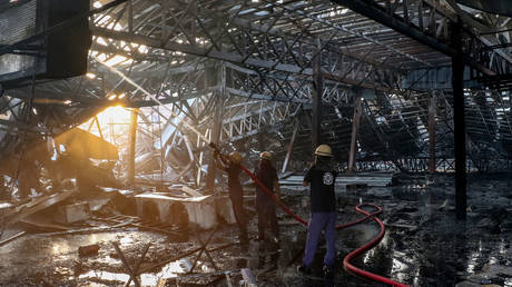 Firefighters extinguish a fire which broke out at an amusement park facility in Rajkot, in India's Gujarat state on May 25, 2024.