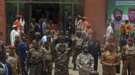 The head of head of Niger's military government General Abdourahamane Tiani (C), Malian Colonel Assimi Goita (3rd R) and Burkina Faso's Captain Ibrahim Traore (2nd R) arrive ahead of the Confederation of Sahel States (AES) summit in Niamey on July 6, 2024.