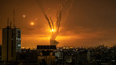 FILE PHOTO: Rockets launched towards Israel from the northern Gaza Strip and response from the Israeli missile defense system known as the Iron Dome leave streaks through the sky.