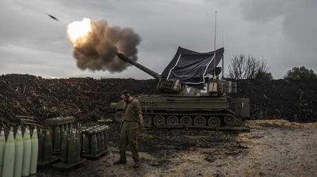 FILE PHOTO. Israelis artillery soldiers fire a mobile howitzer in the north of Israel, near the border with Lebanon.