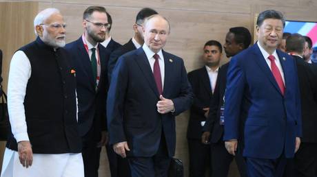 President of Russia Vladimir Putin, President of China Xi Jinping, right, and Prime Minister of India Narendra Modi, left, during a group photo ceremony for the heads of delegation at the 16th BRICS summit in Kazan.