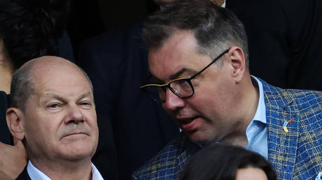 FILE PHOTO: Ukrainian ambassador to Berlin, Aleksey Makeev, (R) talks to German Chancellor Olaf Scholz (L) at a stadium in Nuremberg, Germany, on June 3, 2024.