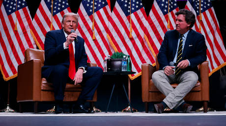 Republican presidential nominee, former President Donald Trump sits down for a conversation with Tucker Carlson during his Live Tour on October 31, 2024 in Phoenix, Arizona.