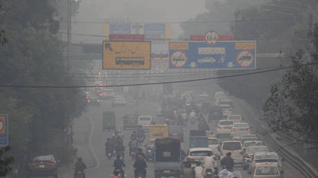 Commuters ride along a road under heavy smog conditions in Lahore, Pakistan on November 01,2021.