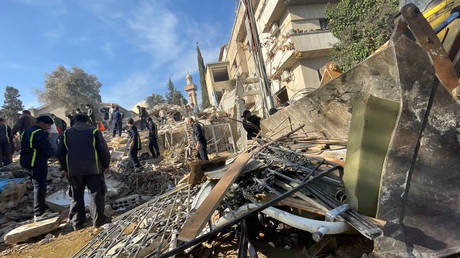 FILE PHOTO: Heavy duty machine removes debris of a destroyed building after Israel's airstrike in Damascus, Syria.