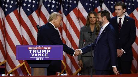 Former US President Donald Trump greets Sen. J.D. Vance during an election night event on November 06, 2024.