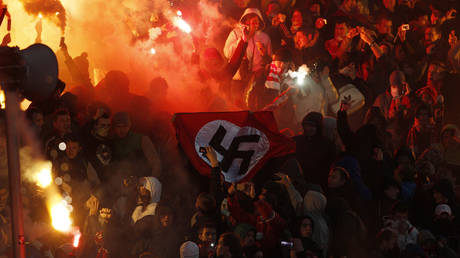 FILE PHOTO: A Nazi flag held by football hooligans during a game in Yaroslavl, Russia in 2013.