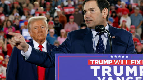 Republican presidential nominee, former US President Donald Trump watches as US Sen. Marco Rubio (R-FL) speaks during a campaign rally in North Carolina, on November 4, 2024.