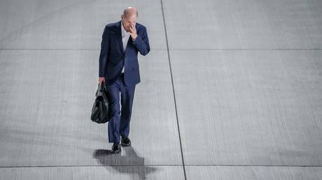 FILE PHOTO: German Chancellor Olaf Scholz walks to the gangway of his plane ahead of a flight to Budapest.