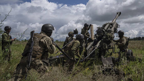 FILE PHOTO: Ukrainian artillerymen fire from a US-supplied M777 howitzer, July 14, 2022.