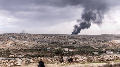 Smoke rises from ongoing battles between Syrian jihadists and government forces near Aleppo, November 27, 2024