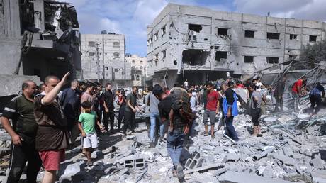 A Palestinian victim is carried away following an Israeli airstrike on Rafah, Gaza, October 17, 2023