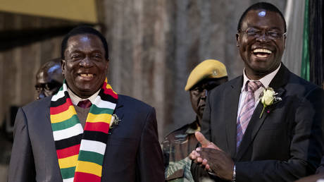 FILE PHOTO: Zimbabwe's President Emmerson Mnangagwa (L) shares a laugh with Zimbabwe Minister for Tertiary Education Amon Murwira at the launch of higher education and tertiary education infrastructure projects at the Rainbow Towers Hotel And Conference Centre in Harare, on July 25, 2018.