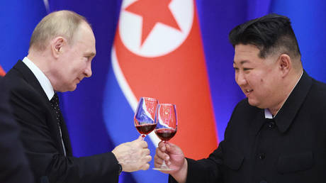 Russian President Vladimir Putin and North Korean leader Kim Jong-un attend a reception at the Mongnangwan Reception House in Pyongyang, North Korea.