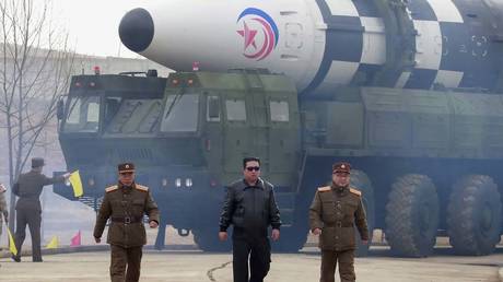 FILE PHOTO: North Korean leader Kim Jong Un, center, walks around what it says is a Hwasong-17 intercontinental ballistic missile (ICBM) on the launcher at an undisclosed location in North Korea.