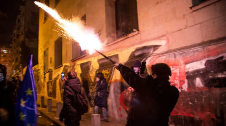 Anti-government activists shoot fireworks at police officers during a protest outside the parliament in Tbilisi, Georgia, November 29, 2024.