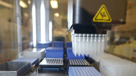 FILE PHOTO. A machine that prepares samples that tested positive for COVID-19 for automated genome sequencing.