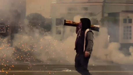 A protester in Tbilisi, Georgia fires a homemade rocket launcher, December 3, 2024.