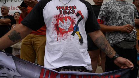 A Polish man wears a T-shirt depicting the Ukrainian slaughter of ethnic Poles in Volhynia during WWII, Warsaw, July 11, 2024.