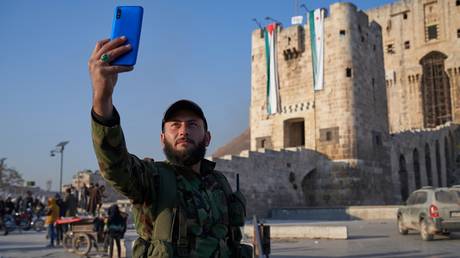 FILE PHOTO: A Syrian anti-government fighter takes a selfie in Aleppo.