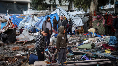 Palestinians inspect the site of an Israeli airstrike on a refugee camp in Gaza on December 4, 2024.