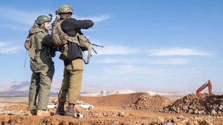 Israeli soldiers standing guard in the Israeli-occupied Golan Heights