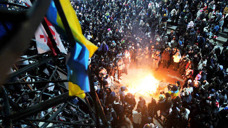 Protesters light a fire and gather in the square in front of the Parliament building, Tbilisi, Georgia, December 8, 2024.