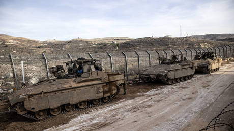 Israeli tanks operate near the Israeli border separating the occupied Golan Heights from Syria, December 9, 2024