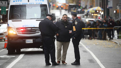 Police gather outside of a Hilton Hotel in Midtown Manhattan where United Healthcare CEO Brian Thompson was fatally shot on December 04, 2024 in New York City.